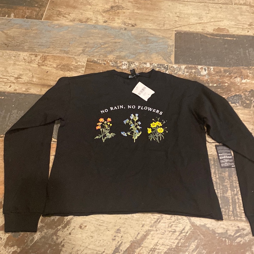 Black Forever 21 cropped long sleeve shirt. Has the words “No Rain, No Flowers”